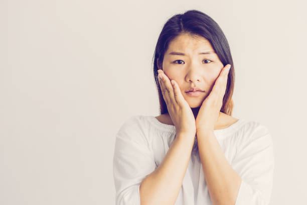 istock Upset shocked young Asian woman touching cheeks 1064434848