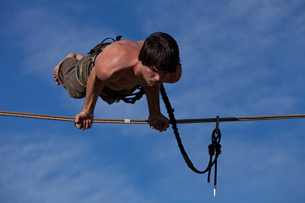 Man Balancing on High Line with Hands stock photo