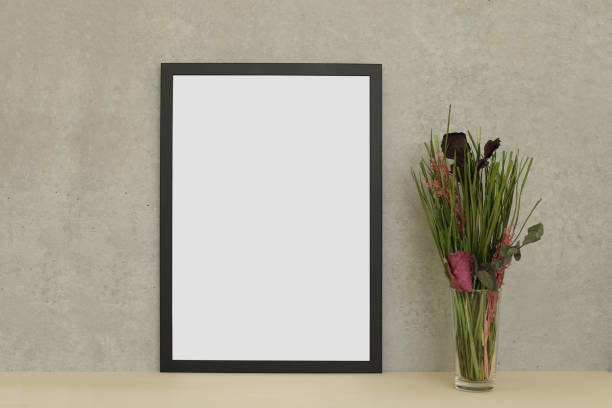 istock Black modern photo frame isolated on wooden table 1064442662