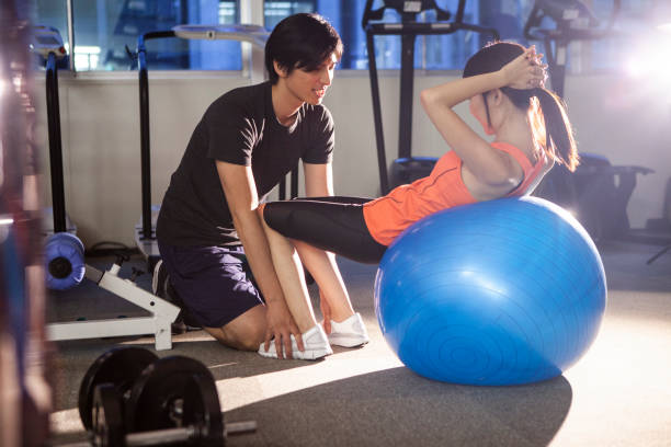 istock Man and woman working out with exercise ball in gym. 1064446464
