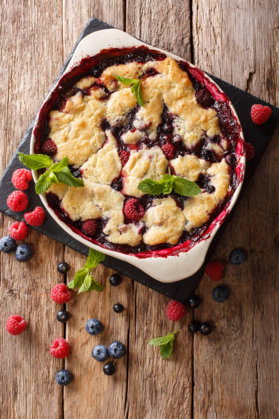 istock Summer berry cake with raspberry berries, currants and blueberries close-up in a baking dish. vertical top view 1064446906