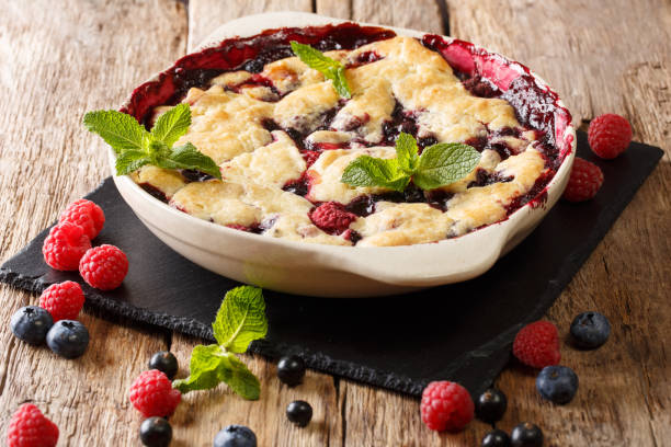 summer berry cake with raspberry berries, currants and blueberries close-up in a baking dish. horizontal - black currant currant black fruit imagens e fotografias de stock