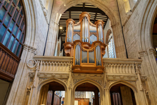 istock Great pipe organ under arched ceiling in old catholic church in England. View from below. Largest musical instrument mostly used in church service in western countries. 1064453602
