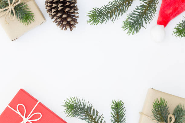 istock Top view of Christmas composition, gift box, pine cones, fir branches on white background and copy space for text information 1064455774