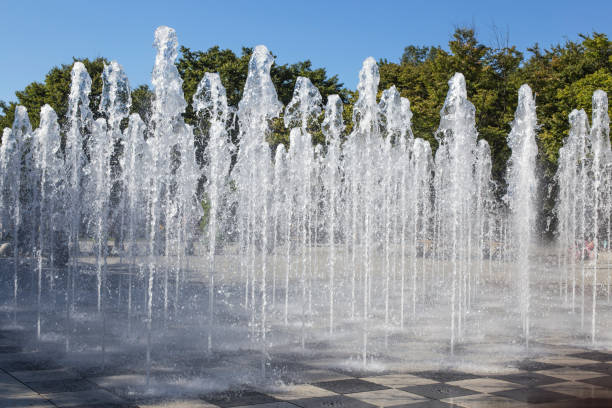 tall fountain spraying from the floor at park.