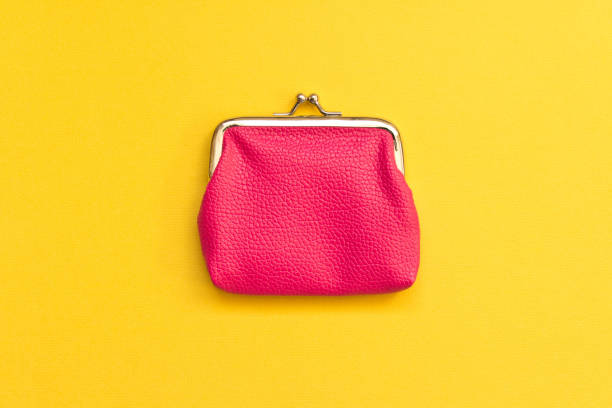 istock Pink wallet on yellow background . Close up. Top view 1064458990