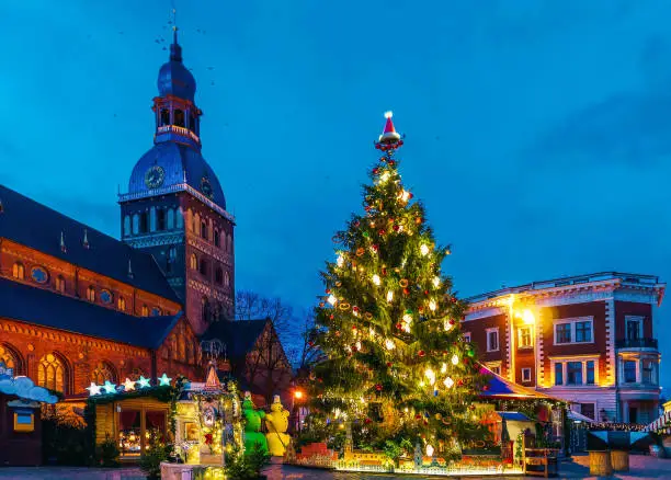 Luminous Christmas tree near the Riga Cathedral at the Christmas market in winter Riga in Latvia.
