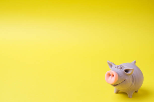 istock Figure funny toy pig on a yellow background. Copy space 1064460928