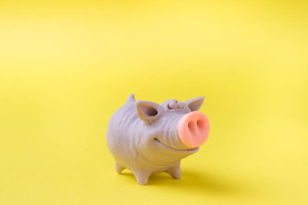 istock Figure funny toy pig on a yellow background. Copy space 1064461144