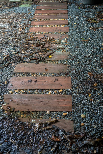istock Stepping wood walkway within grey rock stone. Landscape design. 1064462560