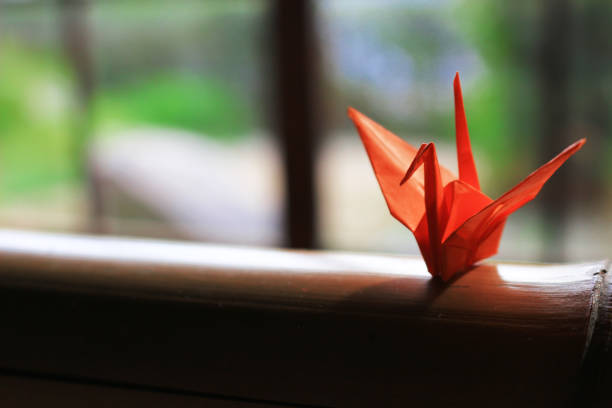 origami crane which is placed on the window side of japanese style houses - origami crane imagens e fotografias de stock