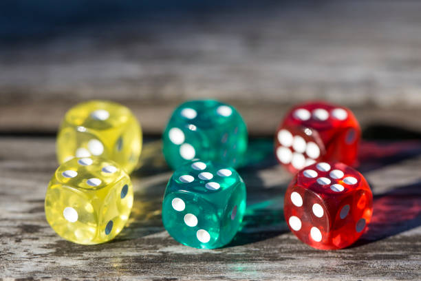 istock colorful dice isolated on wooden table 1064467876