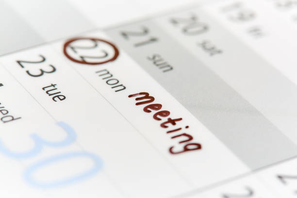 istock Date ringed on calendar or diary and labeled 'meeting' 1064469036