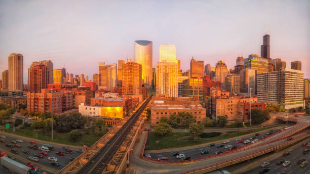 istock Panoramic perspective of Chicago's West Loop during golden hour with traffic on the interstate. Midwest, USA. 1064472240