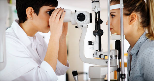 istock Attentive optometrist examining female patient on slit lamp 1064472276
