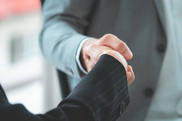 istock business woman with confidence handshake with partner 1064472426