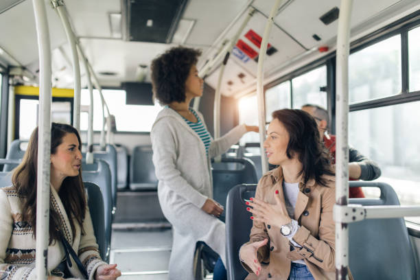 istock Three friends talking in the bus 1064476234