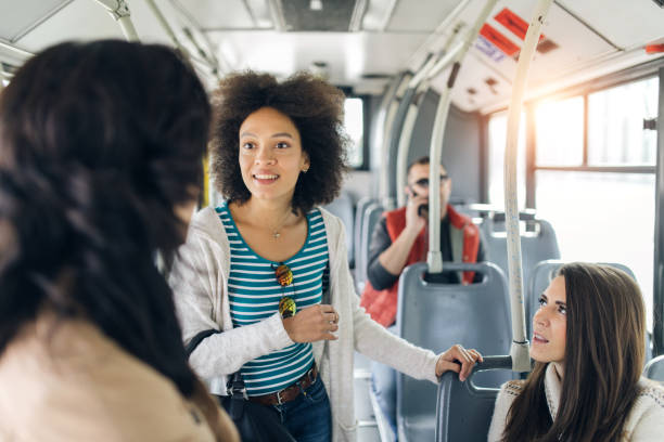 istock Three friends talking in the bus 1064476236