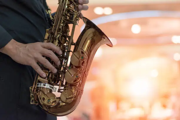 Photo of International jazz day and World Jazz festival. Saxophone, music instrument played by saxophonist player musician in fest.