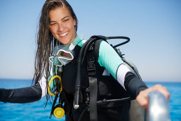 istock Scuba diver girl climbing 1064480600