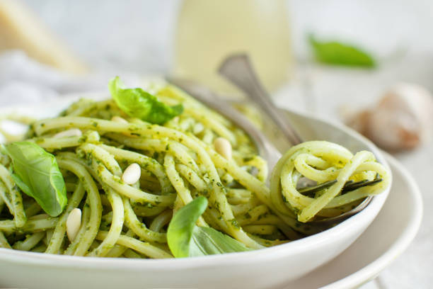 istock Spaghetti pasta with pesto sauce 1064483522