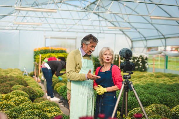 istock Two senior adults vlogging in a greenhouse 1064483950