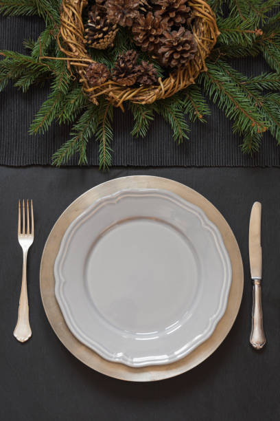 christmas table setting with silverware and dark evergreen decor. top view. holiday centerpieces. - napkin black blank ideas imagens e fotografias de stock