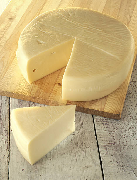 istock wheel of cheese on cutting board 106448526