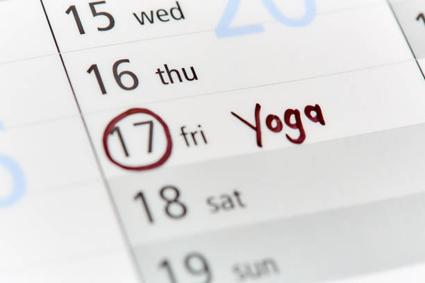 Date ringed on calendar or diary, Thursday 21, labeled 'Yoga' A pen has circled Friday the 17th in a diary or calendar and written "yoga" as an appointment. ring tilt stock pictures, royalty-free photos & images