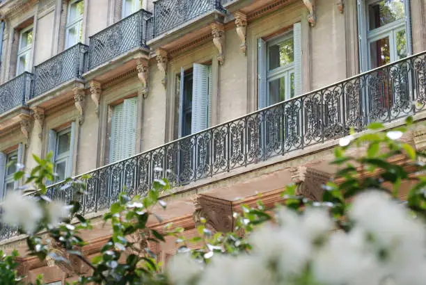 Yellow bricks, façade of a Building in Toulouse. Wrought iron balcony.