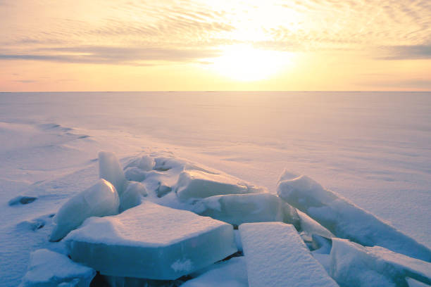 Colorful sunset over the crystal ice of Baikal lake Ice hummock on the ice of lake Baikal on sunrise, Russia. siberia summer stock pictures, royalty-free photos & images