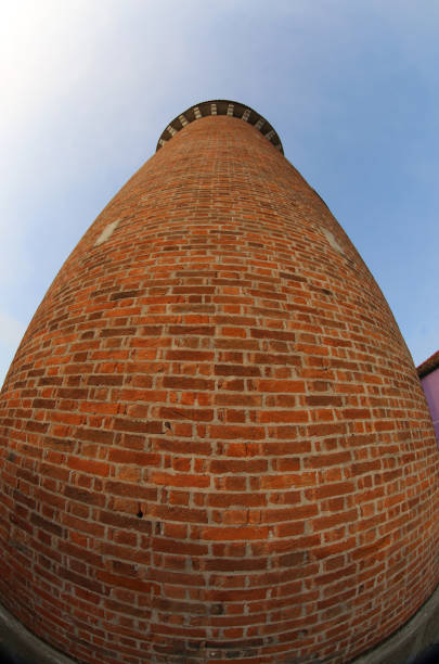 high tower of the old aqueduct made with red bricks photographed with fish eye lens in Italy
