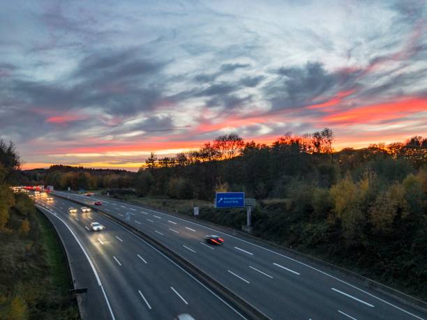 istock Cars driving on german highway under beautiful sunset clouds 1064504134