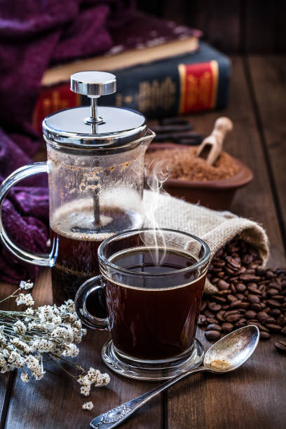 istock Coffee cup and coffee french press on rustic wooden table with copy space 1064506758