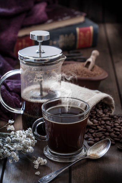 istock Coffee cup and coffee french press on rustic wooden table with copy space 1064506856