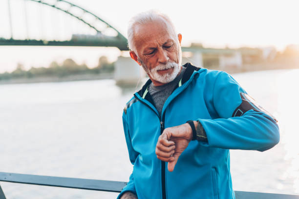 istock Man after running looking at smart watch 1064507648