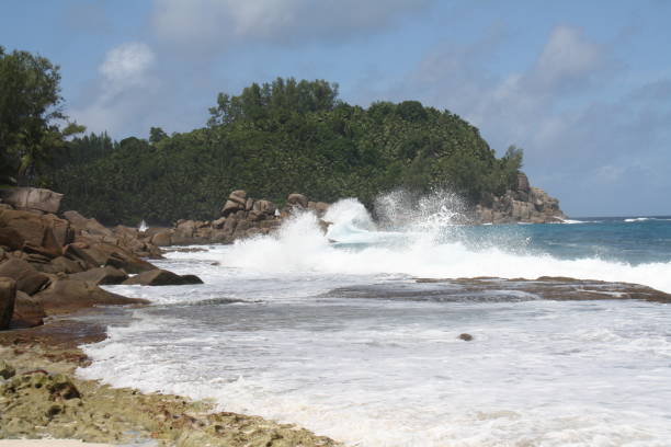 istock Surf on a deserted beach, Seychelles 1064511880