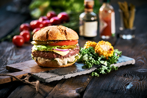 Homemade delicious hamburger  on aged wooden table