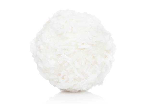 istock Luxury white chocolate candy with coconut flakes and cream on white background. 1064514412