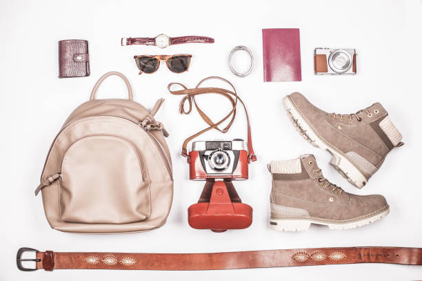 istock Elegant Woman Classical Travel Accessories on White Surface 1064514934