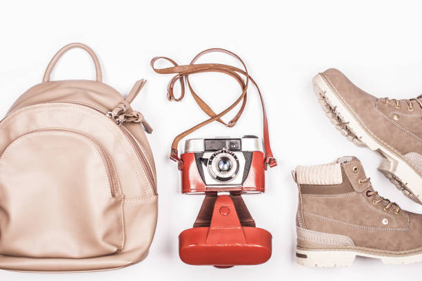 istock Elegant Woman Classical Travel Accessories on White Surface 1064514938