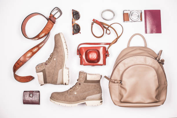 istock Elegant Woman Classical Travel Accessories on White Surface 1064514946