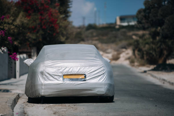 istock Car under a protective cover near house 1064520076