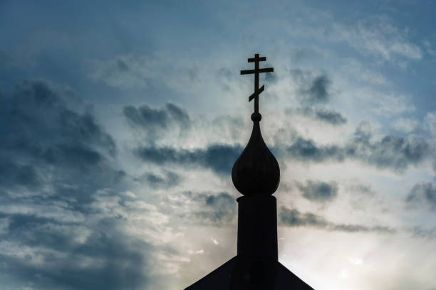 istock A small black church dome with a cross in backlight. 1064524786