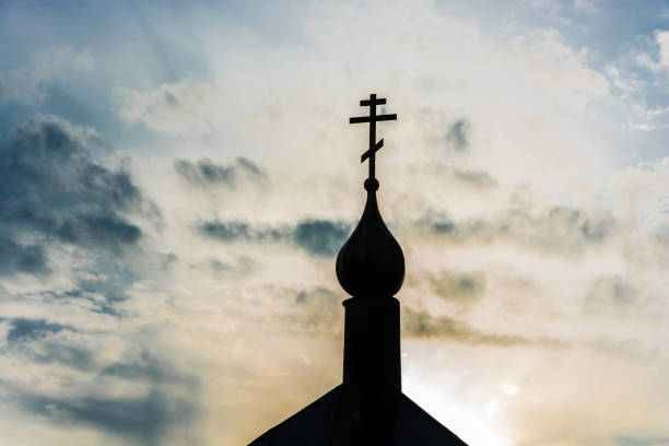 istock A small black church dome with a cross in backlight. 1064524880