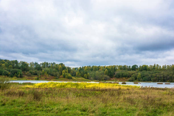 istock Autumn landscape with a river and a cloudy sky on an overcast day. 1064527266