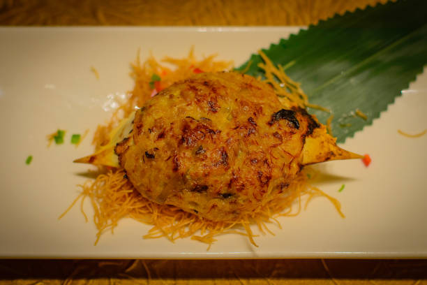 istock Baked crab shell stuffed with crab meat and black truffle paste 1064527348
