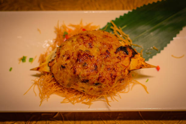 istock Baked crab shell stuffed with crab meat and black truffle paste 1064527430