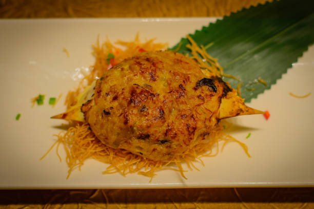 istock Baked crab shell stuffed with crab meat and black truffle paste 1064527618