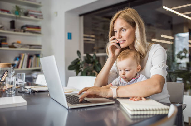 istock Single mother with baby working in office 1064530704